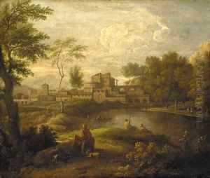 An Italianate landscape with figures by a lake and a town beyond