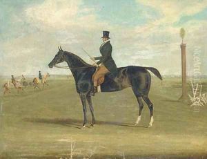 A black racehorse with a trainer up, with horses being exercised beyond