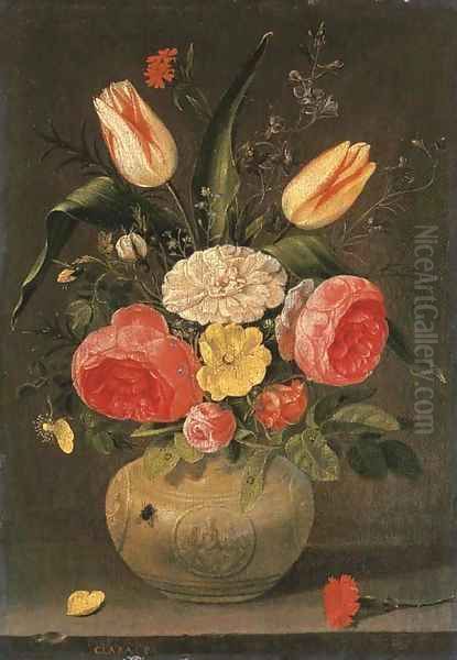 Roses, tulips, carnations and other flowers in a stoneware vase with ornamental relieves on a stone ledge - view 1