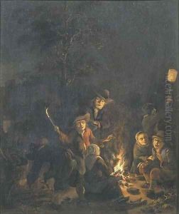 Boors gathered around a bonfire at night