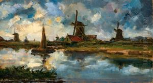 View Of A Mill By The Water At Sunset