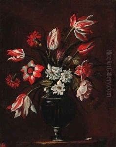 Carnations, tulips and other flowers in a glass vase on a ledge