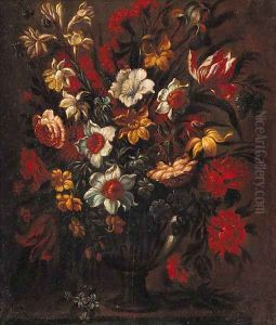 Tulips, daffodils, roses, carnations and other flowers in a vase, on a stone ledge