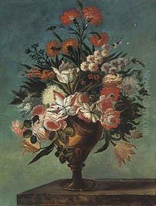 Carnations, roses, tulips, bluebells and other flowers in an urn on a ledge Carnations, roses, tulips, bluebells and other flowers in an urn on a ledge