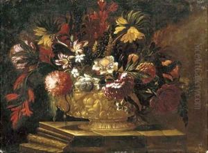 Flowers in a decorative gold vase on a stone plinth