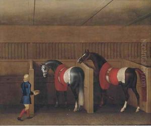 Two racehorses with a groom in a stable