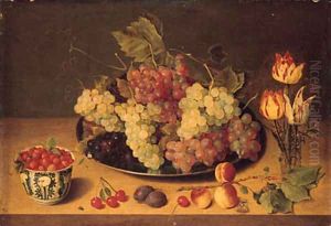 Bunches of grapes and vine leaves on a pewter platte