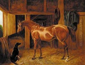 A chestnut hunter with a dog in a stable