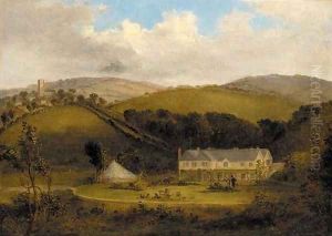 Figures in the garden of a country house, a village beyond by English School