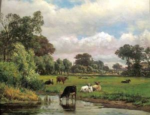 Cows in a meadow, with a village in the distance