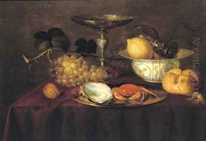 A silver dish with an oyster and a crab, a walnut, white grapes, a silver 'tazza', a porcelain bowl