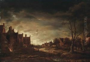 A Moonlit Winter Village, With Figures Around A Bonfire