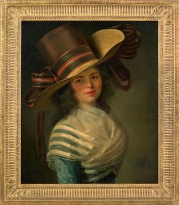 Portrait Of Ayoung Woman Wearing An Elaborate Hat With Ribbon And A Blue Dress