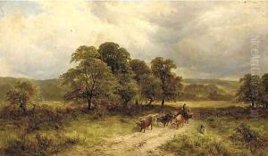 A drover with Highland cattle in a wooded landscape