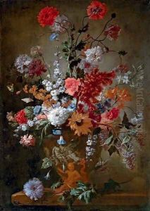 Roses, carnations, a sunflower and other flowers in a classical urn, on stone ledge