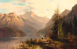 Travellers on the lakeside in a mountainous landscape