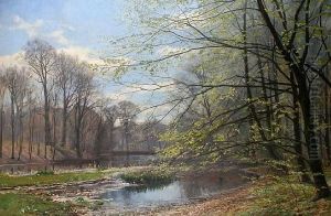 A Wooded Landscape By A Riverside