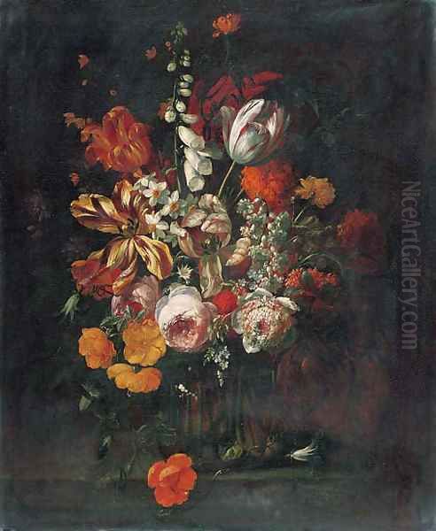 Roses, tulips, narcissi, a foxglove and other flowers in a glass vase on a ledge - view 1