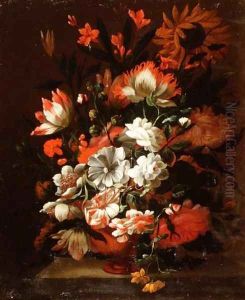 Tulips, carnations, sunflowers and other flowers in an urn on a stone ledge