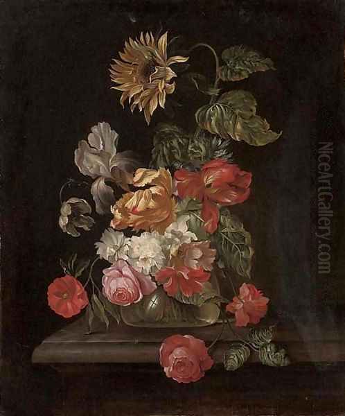 Roses, parrot tulips, an iris, anemones and a sunflower in a glass vase on a stone ledge - view 1