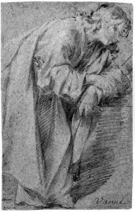 A man leaning forward resting on a ledge