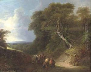 A wooded landscape with travellers on a track by Lodewijk De Vadder