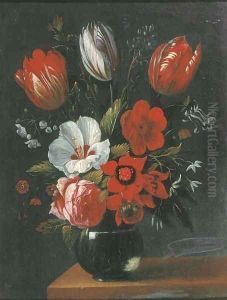Tulips, roses and other flowers in a glass vase on a wooden ledge