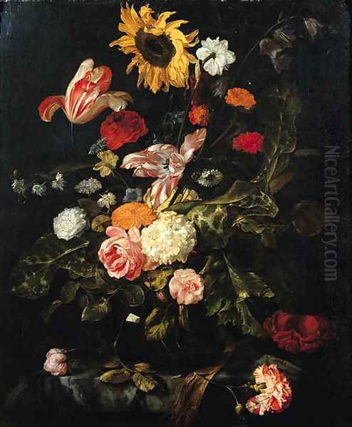 A sunflower, roses, parrot tulips, a carnation and other flowers in a glass vase on a partly draped marble table - view 1