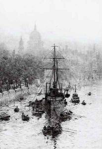 The President lying on her permanent mooring on the Thames by William Lionel Wyllie