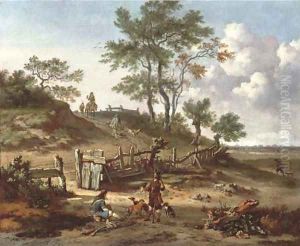 A hilly landscape with a huntsman and a falconer resting by a gate and other huntsmen on a path by Jan Wijnants
