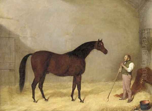 A bay hunter with a groom in a stable - view 1