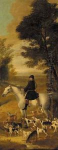 A huntsman on a grey hunter, with harriers in an extensive wooded landscape