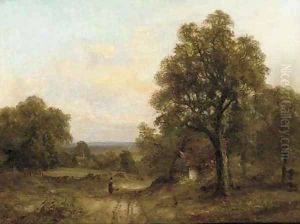 A figure on a track in a wooded landscape