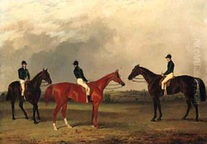 A chestnut and two bay racehorses with jockeys up in an extensive landscape