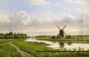 A Summer Landscape With A Windmill Along A Waterway