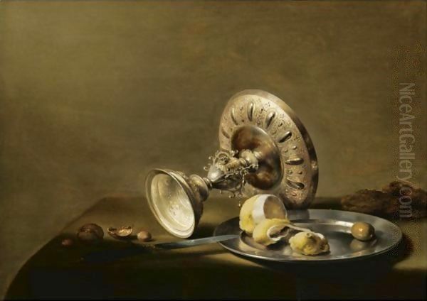 A Still Life With An Overturned Silver Tazza, A Silver Plate With A Partly Peeled Lemon And An Olive, With Walnuts And Hazelnuts - view 1