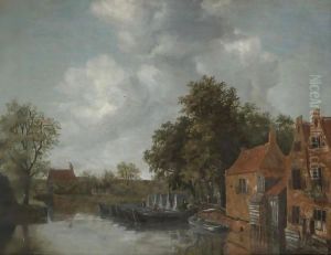 A View On A Canal In A Dutch Village With Barges Moared On The Quay Near Houses
