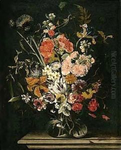 Still Life Of Tulips, Carnations, Stocks, Irises, Thistles And Lilies, In A Glass Vase, Upon A Stone Ledge