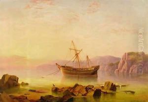 A ship at anchor in a bay at sunset