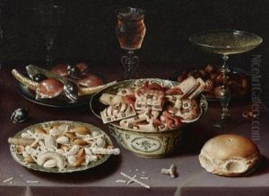 A Still Life Of Porcelain Vessels Containing Sweets, Pewter Plates Bearing Sweets And Chestnuts, Three Pieces Of Glassware And A Bread Roll On A Table Draped With A Mauve Cloth