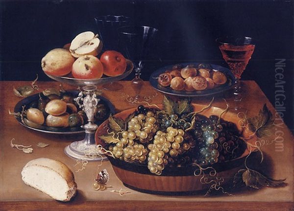 A Silver Tazza Of Apples, A Lacquer Bowl Of Grapes, Two Pewter Plates With Plums And Medlars, Half A Bread Roll And Wine Glasses On A Wooden Table - view 1