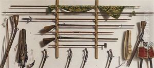 A Trompe L'oeil Of A Leading Staff, A Partizan, A Matchlock Musket, A Longbow, A Fowling Piece And Other Weaponry Hanging On A Wall