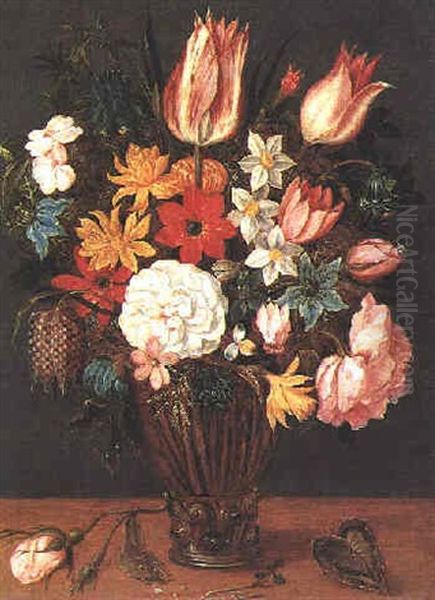 A Still Life Of Tulips, Roses, Anemones, Aquilegia, Love-in-the-mist, Rosemary, Narcissi, A Fritillary And Other Flowers In A Glass Vase Beside A Rose Stem On A Table - view 1