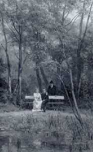 An Elegant Couple Seated On A Bench In A Park With An Attendant Standing Nearby