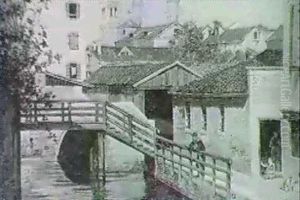 Figures On A Walkway Beside A Venetian Canal by Antonietta Brandeis
