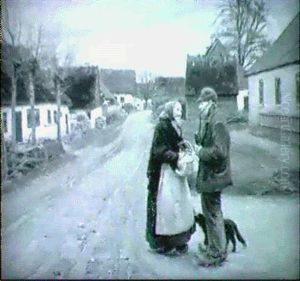 Dansk Byvag Med Man Och Kvinna Samt Hund by Hans Andersen Brendekilde
