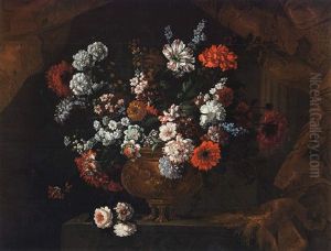 A Still Life Of Flowers In A Gilt Urn, Resting Upon A Stone Ledge