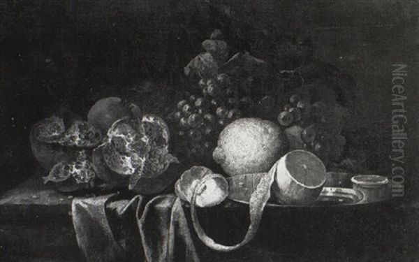 A Lemon On A Silver Plate With Pomegranates And Grapes On A Draped Table - view 1