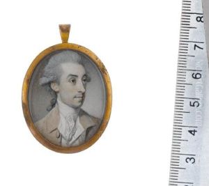 A Gentleman, Wearing Light Brown Coat, White Waistcoat, Stock And Lace Cravat, His Powdered Wig Worn En Queue And Tied With A Grey Ribbon Bow