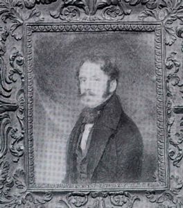 Portrait Of A Gentleman In Black Coat With Red Draped Curtain Background